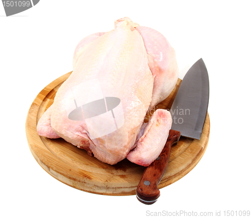 Image of Uncooked chicken on a cutting board.