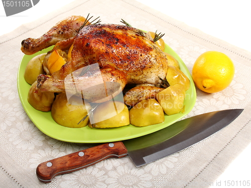 Image of Chicken stuffed with lemons, apples and rosemary.