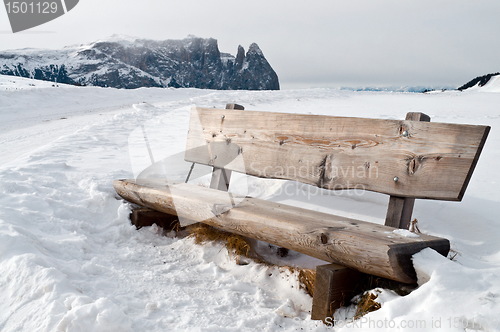 Image of isolated bench in snow scape