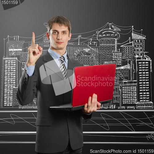 Image of male in suit with laptop with idea