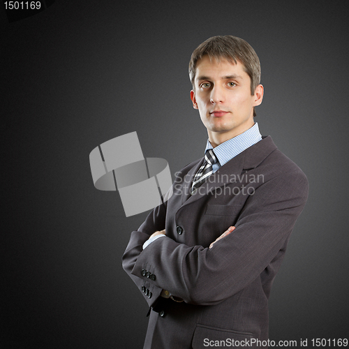 Image of male in suit with folded hands