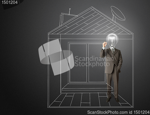 Image of businessman with lamp-head and marker in house