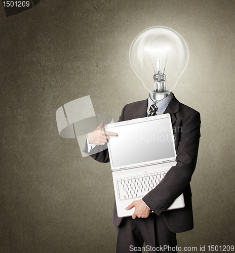 Image of businessman with lamp-head with open laptop shows something