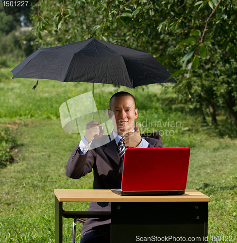 Image of businessman with umbrella