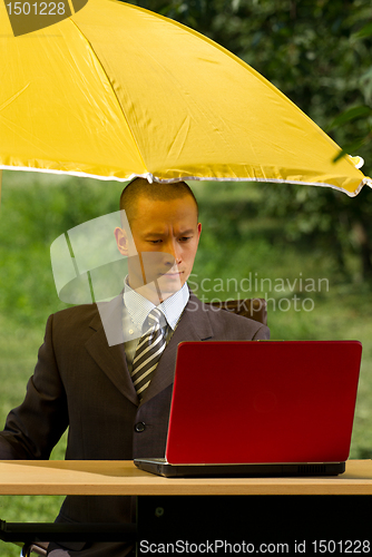 Image of businessman with umbrella