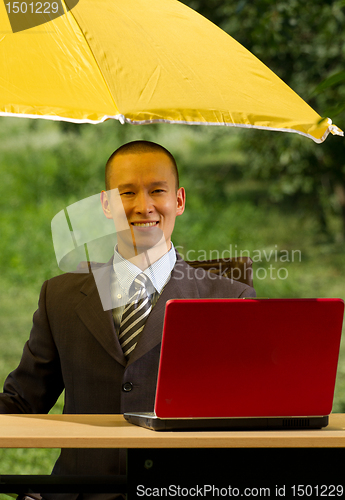 Image of businessman with umbrella