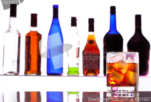 Image of Alcohol drink with bottles on the background