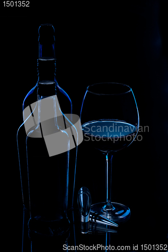 Image of silhouette of bottles with glass of wine