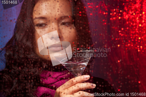 Image of Sad Asian woman with drink in cold rainy weather