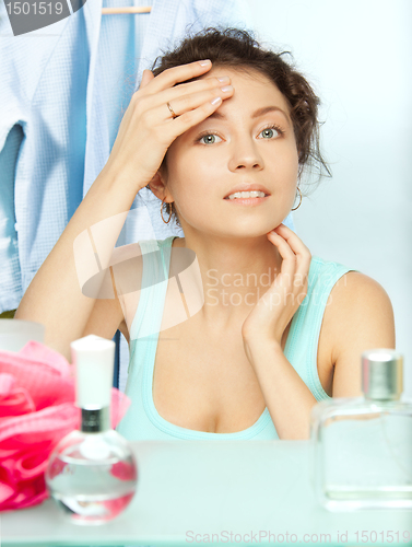 Image of Woman inspecting skin for spots