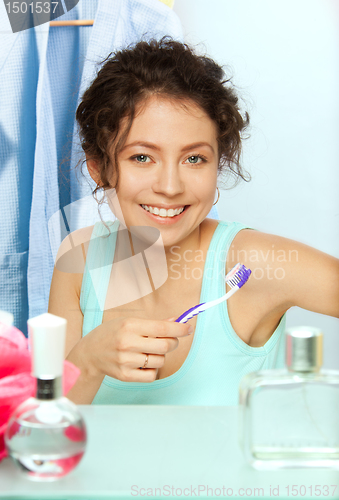 Image of Laughing woman with toothbrush