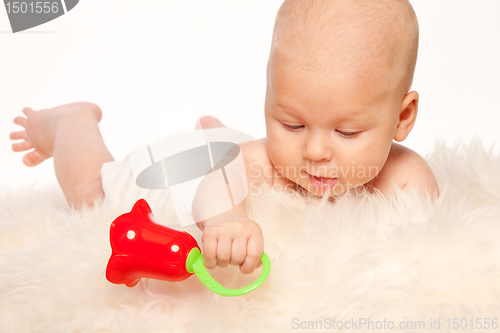 Image of Baby playing with rattle