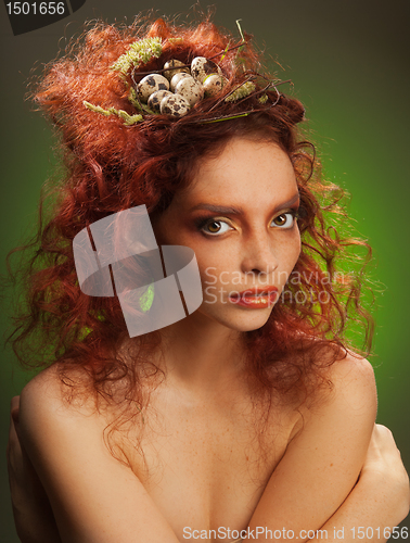 Image of nest with eggs in woman's hair