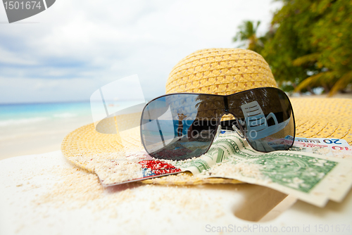 Image of Straw hat, shades and money - all you need to relax on the beach