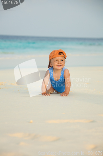 Image of Happy kid crawling on the beach