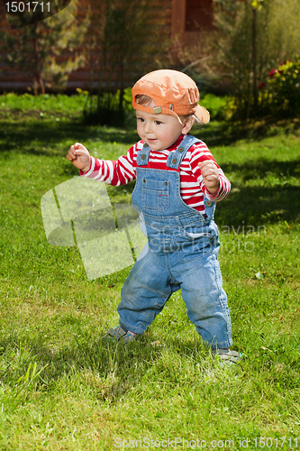 Image of Toddler make first steps in the garden