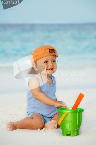 Image of Kid playing with sand on the beach