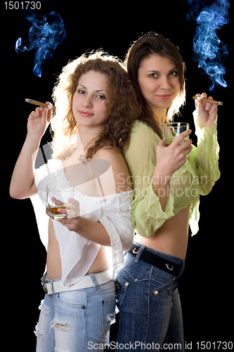 Image of Two smiling pretty girlfriends with a cigars