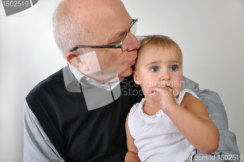 Image of Senior man kissing daughter 