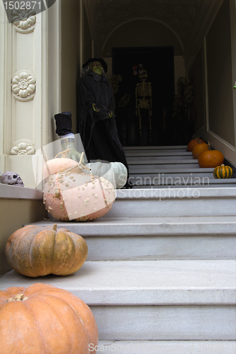 Image of Halloween Decoration in Front of House with Witch