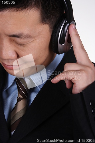 Image of Asian businessman listening