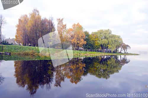 Image of Beautiful lake and autumn trees reflect on water.