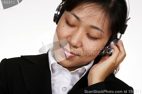 Image of Asian businesswoman listening