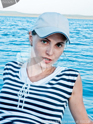 Image of Girl, portrait against the background of the lake.