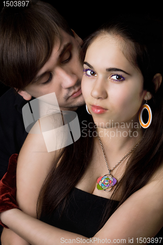 Image of Portrait of the loving young couple. Isolated on black