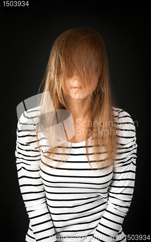 Image of hair covers her face with a young girl