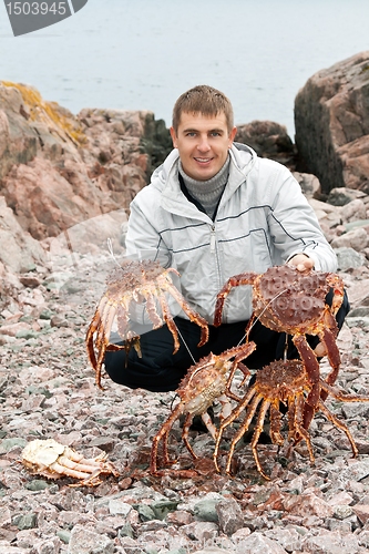 Image of man with crabs in the Barents Sea coast