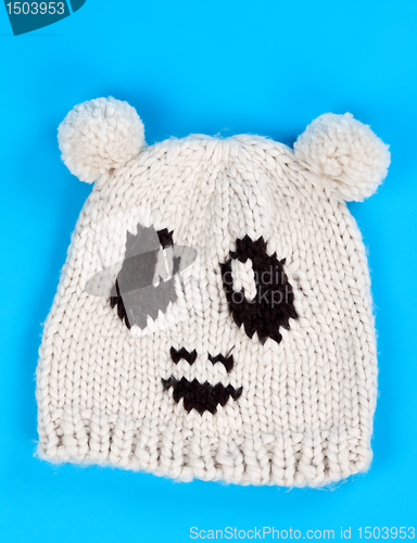 Image of knitted wool hat with a pattern of little faces