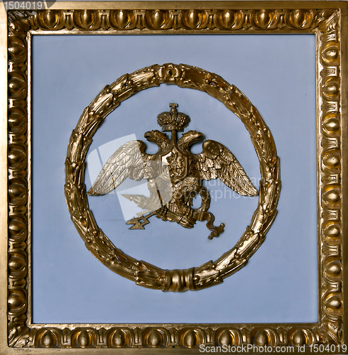 Image of gold double eagle in a frame on a gray background.