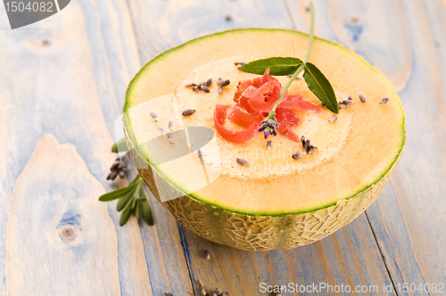 Image of fresh melon soup with parma ham and lavender flower