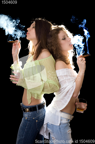 Image of Portrait of the two pretty girlfriends with a cigars
