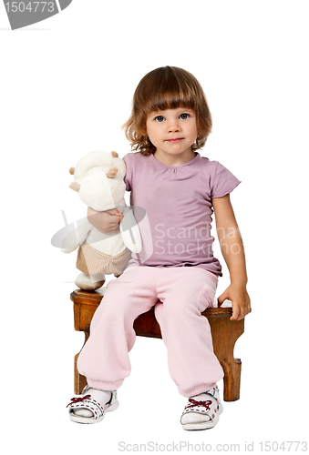 Image of little girl sitting on a wooden stool