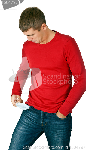 Image of man looks with interest at his empty pocket