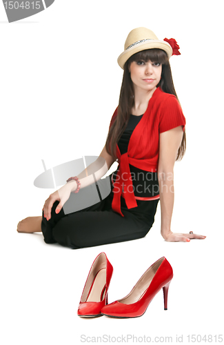 Image of Beautiful girl on the background of a pair of red women's shoes.