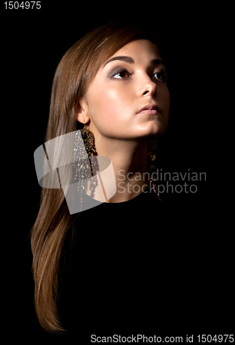 Image of portrait of a girl's face in the darkness.