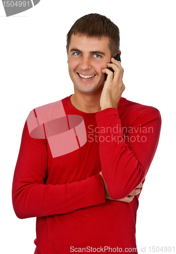 Image of man in a red dress speaks on a mobile phone.