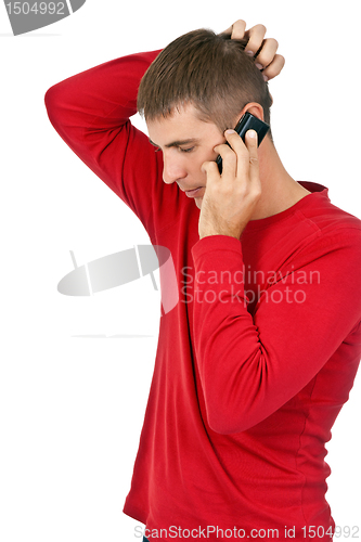Image of man in a red dress speaks on a mobile phone.