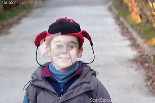 Image of Cute little boy head in a funny hat outdoor in autumn