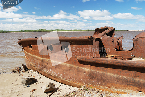 Image of rusty ship on the shore 