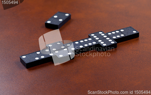 Image of Game of dominoes on leather table