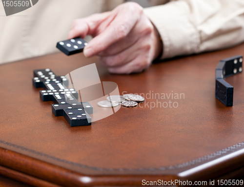 Image of Game of dominoes on leather table