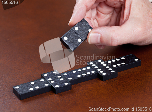Image of Game of dominoes on leather table