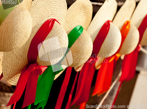 Image of Row of straw hats with ribbons