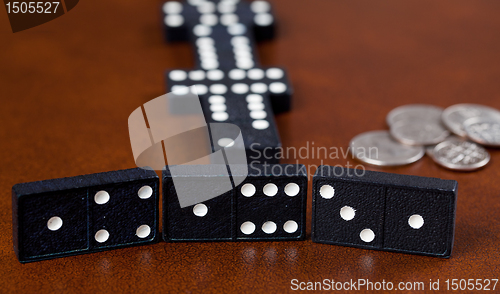 Image of Game of dominoes on leather table