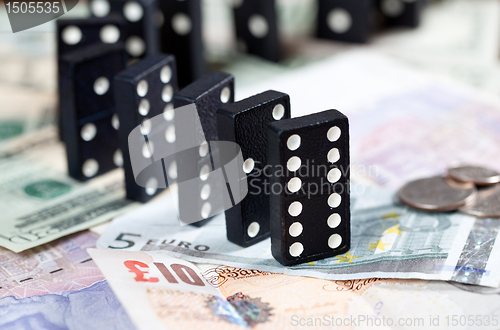 Image of Standing dominoes on bank notes