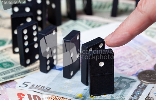 Image of Standing dominoes on bank notes